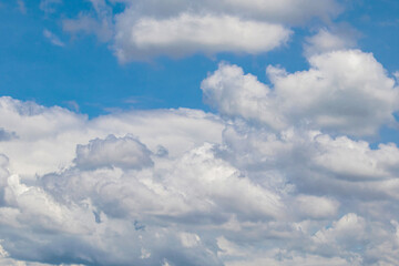 The blue sky with the white clouds in the sunny day of summer. 