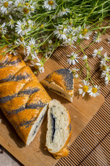 Bun with milk on the table with daisies