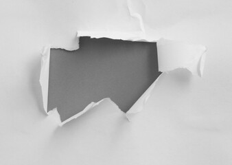 Ripped paper on gray background, space for advertising copy.
