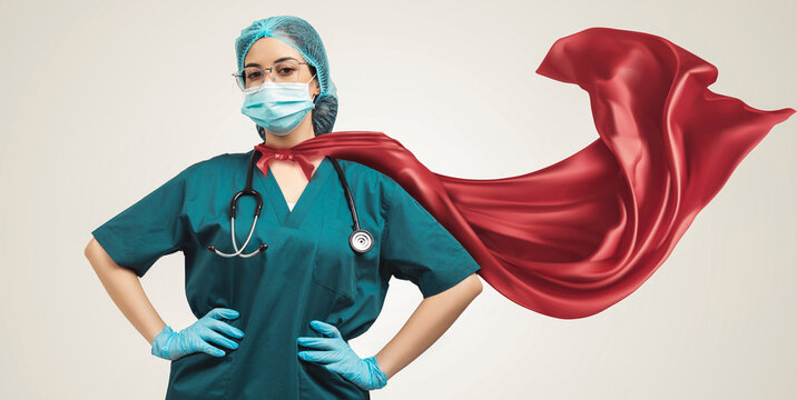 Doctor in superhero cape. Concept of super heroism medical staff during coronavirus outbreak, standing on grey background.