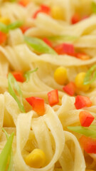 noodles with paprika, green onion and sweet corn, close up