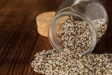 Glass bowl with chia seeds on wooden table