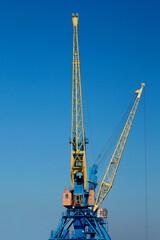 A Crane boom with main block and jib against a clear blue sky