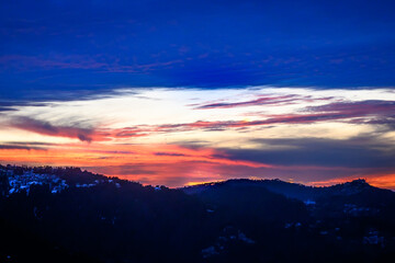 Colorful, vibrant, burning sunset skies, dramatic clouds  Himalayan mountains on Trek to Dalhousie