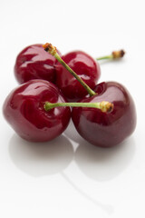 red cherries on a white background close up