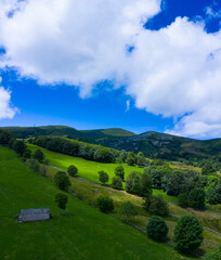 Obraz premium Landscape from a drone in Portillo de la Sia. Meadows, huts and beech forests. The Merindades. Burgos province. Community of Castilla y León. Spain, Europe