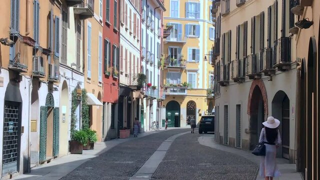 Italy, Milan July 2020 - Drone aerial view of Brera district  after finish of lockdown due COVID-19 Coronavirus outbreak - typical colored houses and tourist with mask walking in pedestrian zone area