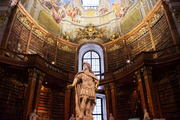 The Prunksaal statue center of the old imperial library for Austrians people and foreign travelers travel visit at State Hall of Austrian National Library on September 24, 2019 in Vienna, Austria - obrazy, fototapety, plakaty