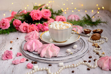 Black coffee with marshmallows and pink meringues. Bouquet of pink roses. Romance. Good morning
