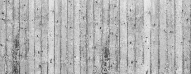 Obraz na płótnie Canvas Panorama Detail einer grauen Wand aus grobem Sichtbeton mit vertikalem Streifenmuster