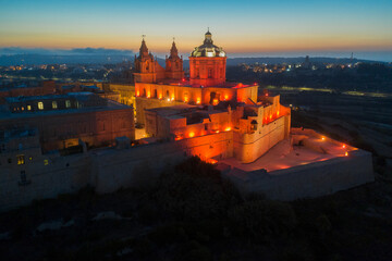 Aerial view of Mdina city - old capital of Malta. Night, evening. sunset, red street lamp and light