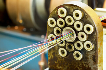 Fragment strands of optical fiber connections on the old cable machine. Manufacture of optical...