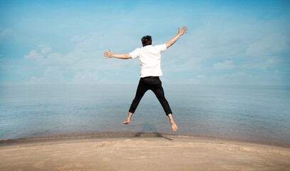 freedom jumping man on beach