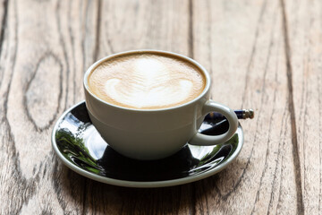 hot caramel macchiato coffee on wooden table