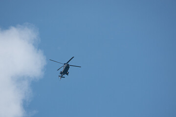 Fototapeta na wymiar big helicopter flies in the blue sky