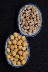 dry and soaked chickpeas in a bowl on a dark background