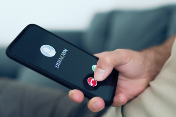 close-up view of person rejecting call from unknown caller or unknown number on smartphone, phone...