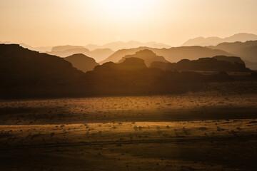 Fototapeta na wymiar Golden sunst over a mountain range in Jordan