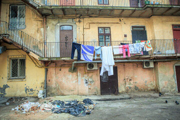 old inner courtyard with different clothes drying on balcony in historical Lviv city