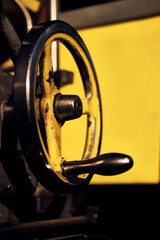 metal handle of old yellow industrial machine at the factory