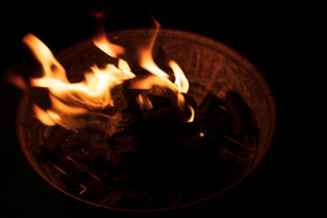 flames from a charcoal fire in a grill