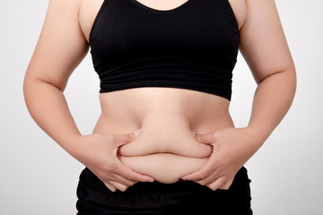 Asian obese women are overweight. She touched her fat belly.
