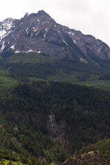 view of a mountain from top to bottom with a  forest around