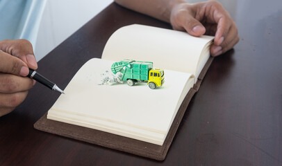 Hand holding a pen for sign business document notebook