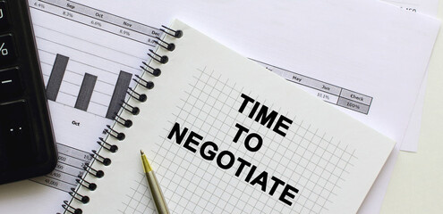 Text Time to negotiate on the page of a notepad lying on financial charts on the office desk. Near the calculator. Business concept.