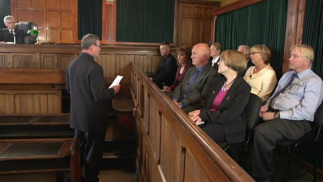 Male Barrister / Lawyer addressing the Jury in Court or Courtroom. Wide Shot. Stock Video Clip Footage
