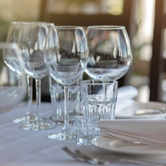 Empty glasses in restaurant background. Table set for an event party or wedding reception.
