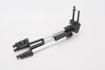 A collapsed tripod against a white background.