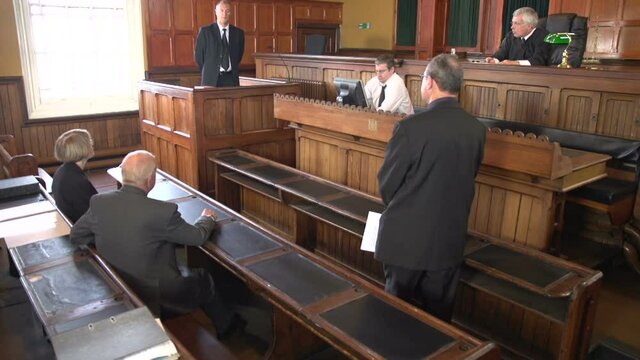 Witness being questioned by a Male Barrister / Solicitor in Court or Courtroom. Stock Video Clip Footage