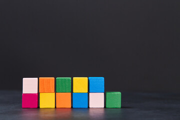 Colourful cubes for inscription on dark background, place for text