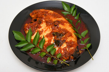 Telapia Karimeen Mulaku Curry is a hot and spicy fish curry seafood cuisine of  Alappuzha Kerala cooked with coconut milk. Popular dish in coastal area of Sri Lanka and India