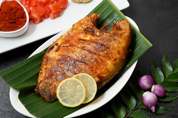 Kerala fish curry, Karimeen Pollichathu a popular hot and spicy baked fish in banana leaves...