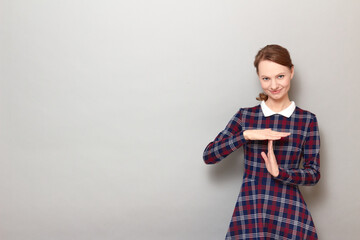 Portrait of happy girl showing timeout gesture with hands and smiling