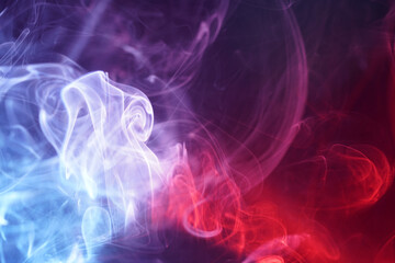Multi colored smoke from an incense stick with color foils Photographed in front of the flash in the studio