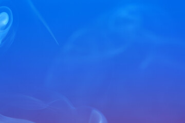 Multi colored smoke from an incense stick with color foils Photographed in front of the flash in the studio