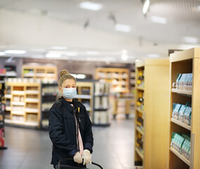 Supermarket shopping, face mask and gloves,Woman choosing a dairy products at supermarket