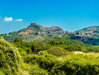 Fototapeta na wymiar A view across the fields to the hilltop settlement of Castiglione di Sicilia in the foot hills of Mount Etna, Sicily in summer