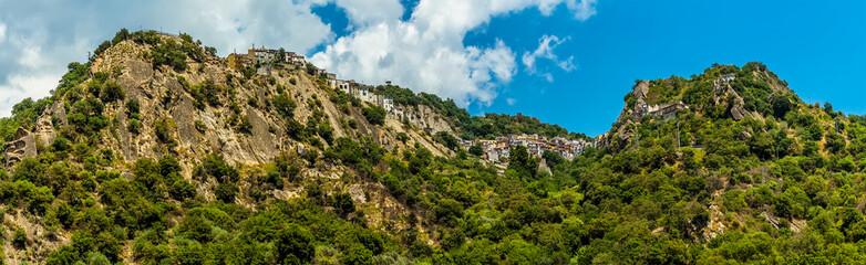 Fototapeta na wymiar The settlement of Motta Camastra, Sicily perched on hill tops in the foot hills of Mount Etna near Taormina, Sicily in summer
