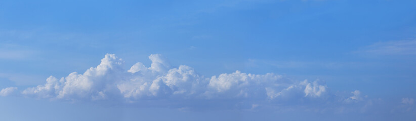 cumulus clouds on a blue sky panoramic background