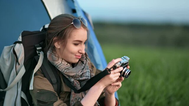Backpacker tourist woman making photo use camera admiring nature. Medium shot on RED camera