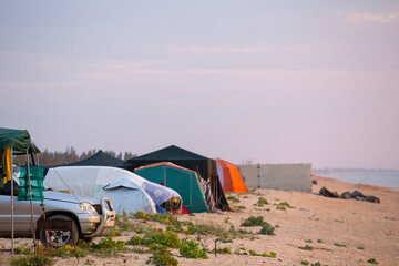 closeup touristic camp on a sea coast at the early morning, summer camping scene