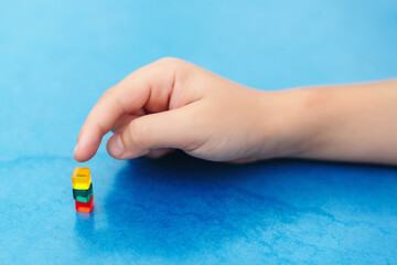 Child playing with mini blocks. Interesting game for kids to develop fine motor skills.