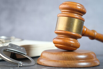  gavel, book and handcuff on table, close up 