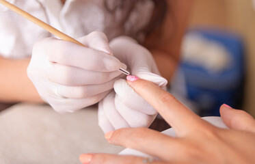 Obraz na płótnie Canvas Nail manicure. Nail painting. Woman in salon receiving manicure.