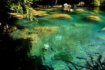 A magnificent crystal clear blue lake in the mountains. Swiss Alps. Summer mountain landscape. Blue water.