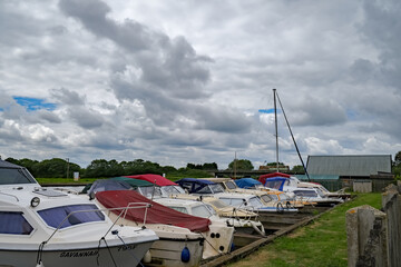 26 Row of old and tired motorboats in need of some tlc moored on the River Thurne in the Broads National Park